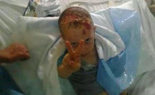 Filistinli çocuktan sedye üzerinde zafer pozu